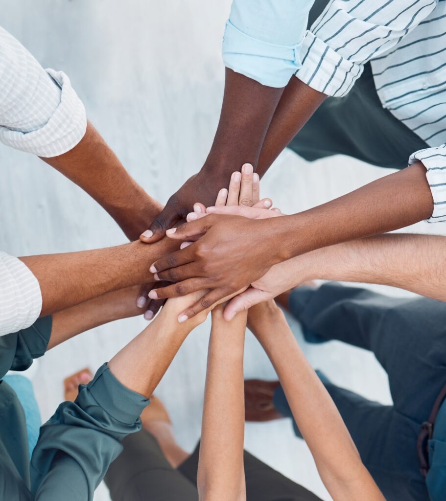 Image of hands in a circle like a team.